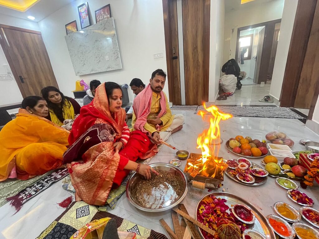 Havan fire burning as a family offers ahutis during a Navgraha Shanti Puja at home in Delhi NCR