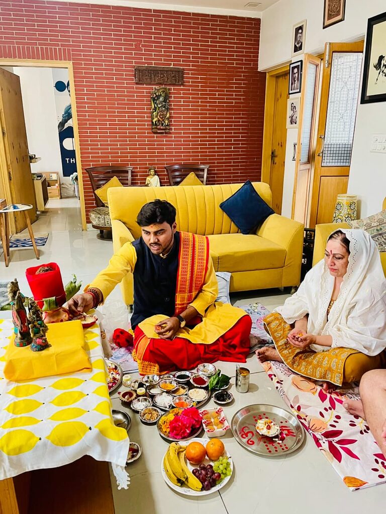 Vandanam pandit performing a Navgraha Puja for a couple in their living room in Delhi