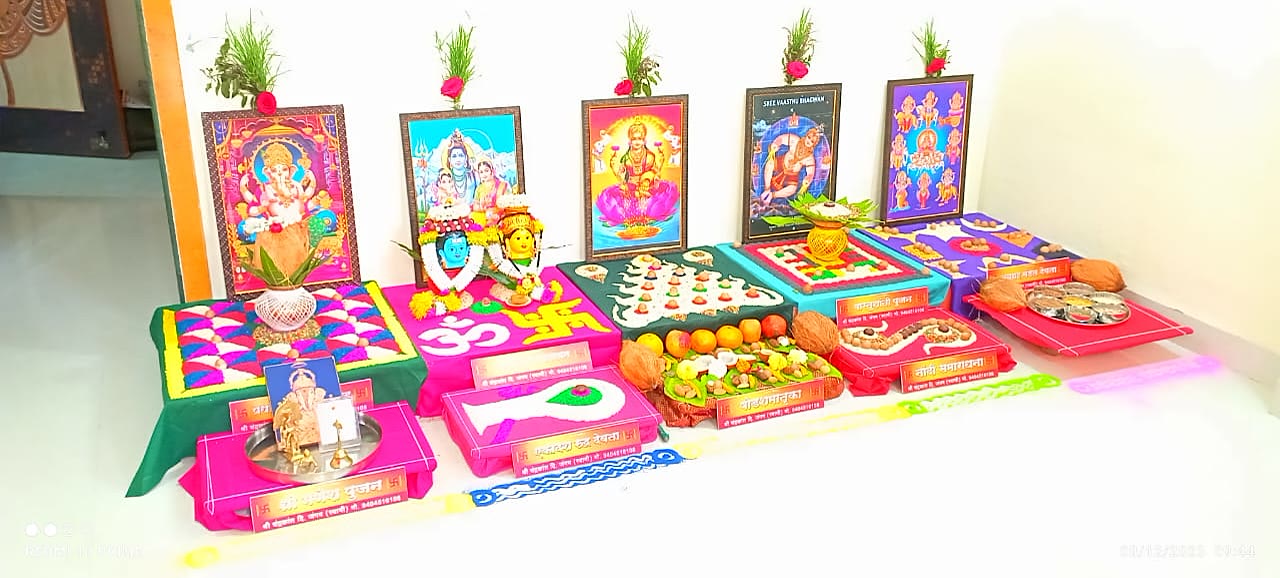 Puja chowkis prepared with deity frames, coloured grain mandalas and thalis before the ceremony