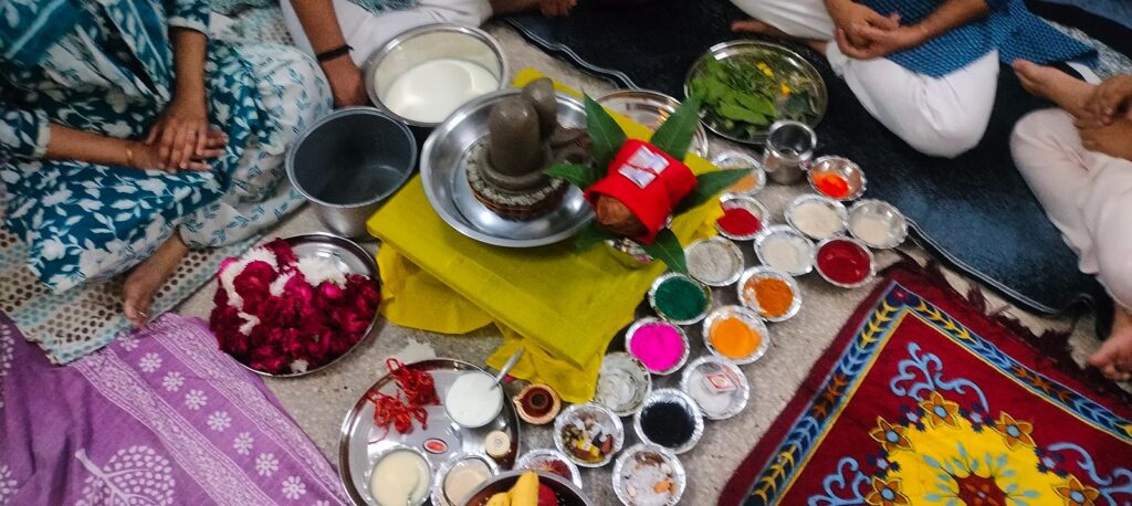 Shivling and complete Rudrabhishek puja samagri laid out on the floor at a home in Delhi