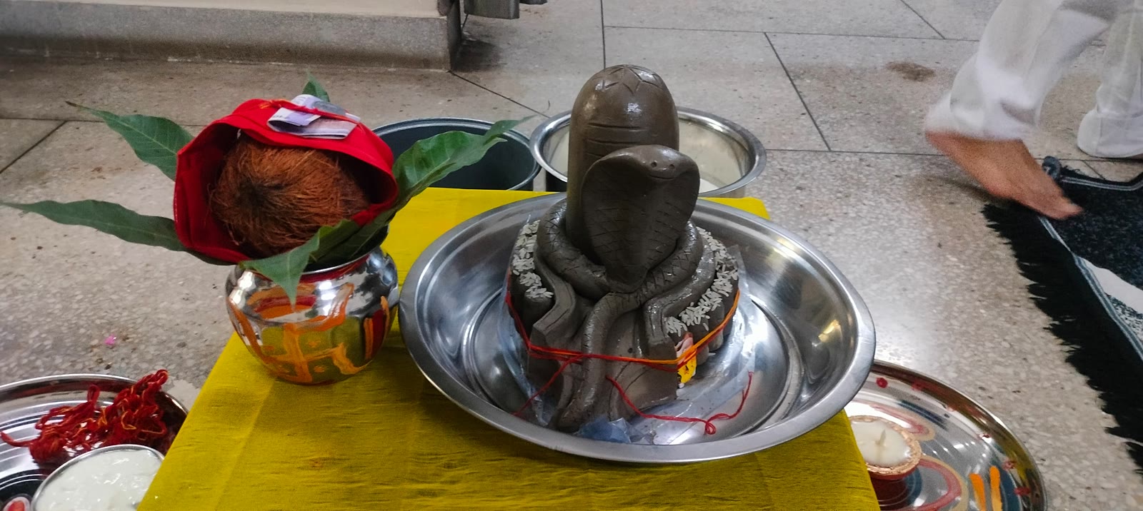 Shivling in an abhishek thali with a decorated kalash and coconut during Rudrabhishek at home