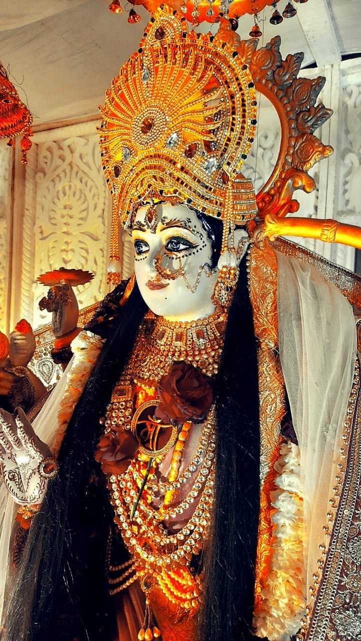 Close-up of the Mata Durga idol's gold crown and jewelled ornamentation at a Chowki darbar
